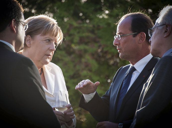 GER0002 - Berlin, Berlin, GERMANY : This handout photo made available by the German government press office shows German Chancellor Angela Merkel (L) speaking with French President Francois Hollande during their statements at the start of their meeting at the chancellery in Berlin, on August 23, 2012. Merkel and Hollande will discuss debt-wracked Greece after Athens' plea for more time to implement crucial but painful reforms to safeguard its eurozone membership. RESTRICTED TO EDITORIAL USE - MANDATORY CREDIT "AFP PHOTO/ GUIDO BERGMANN/ BUNDESREGIERUNG" NO MARKETING NO ADVERTISING CAMPAIGNS - DISTRIBUTED AS A SERVICE TO CLIENTS
