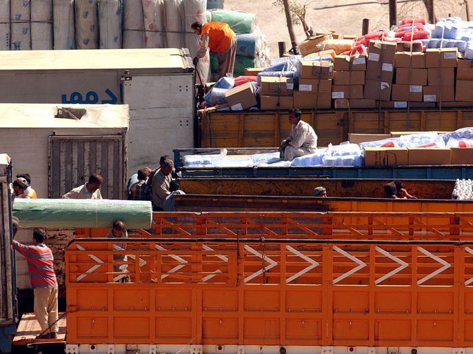 Goods are transferred from trucks licensed to operate in Iran (L) to trucks licensed to operate in Iraq (R) along the Iran-Iraq border near the border town of Khanaqin, Iraq, Saturday 11 October 2003. With the exception of some humanitarian shipments, most goods are exchanged between the two countries in this manner. EPA/STEFAN ZAKLIN