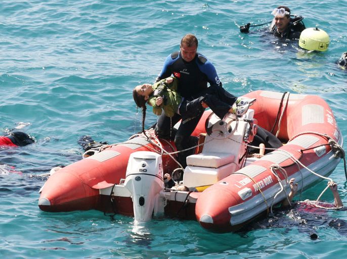 A diver carries a young girl, after a boat carrying illegal immigrants trying to reach Europe capsized in waters off western Turkey, on September 6, 2012 near Izmir. Forty-five people including two crew members were rescued alive, and at least 39 people drowned. The captain and his maid who were among the survivors were detained