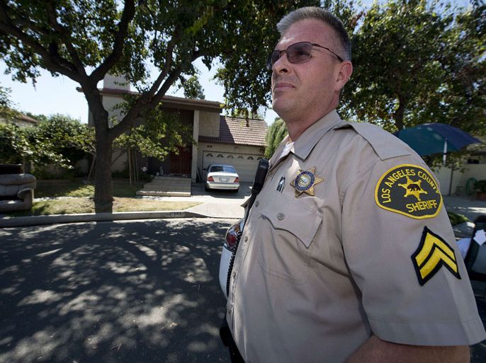 Los Angeles County Sheriff's Deputy Aaron King patrols in front of the home of Nakoula Basseley Nakoula, believed to be the maker of the film "Innocence of Muslims" which has caused unrest against the US in the Middle East, on September 15, 2012 in Cerritos, California. Nakoula was taken to a local Sheriff's office shortly after midnight to be interviewed by federal probation officers but was not arrested or detained and has "left the area", authorities said Saturday