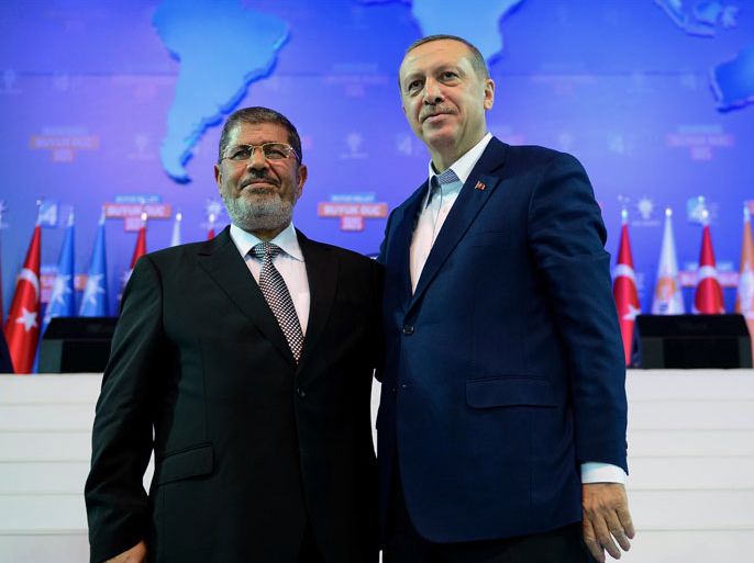In this photo provided by Turkish Prime Minister's Press Service,Turkey's Prime Minister Recep Tayyip Erdogan, right, and Egyptian President Mohammed Morsi salute the members of Turkey's ruling Justice and Development Party in Ankara, Turkey, Sunday, Sept. 30, 2012. Morsi is in the Turkish capital to strengthen an emerging alliance between two moderate Islamist governments in a region beset by conflict and instability. Even though Morsi has only been in power for a few months, there are already strong signs a partnership with Turkey is forming, evidenced by a common effort to end Syria's civil war by urging the exit of President Bashar Assad from power.