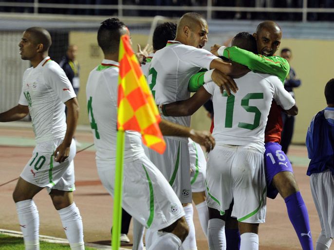 ALGERIA : Algeria's Soudani al-Arabi Hillal (15) celebrates with team mates after he scored a goal in their match against Libya in the second leg of their African Nations Cup qualifying soccer match at Tacheker stadium in Blida, southwest of Algiers, on October 14, 2012. Algeria won 2-0. AFP PHOTO/FAROUK BATICHE