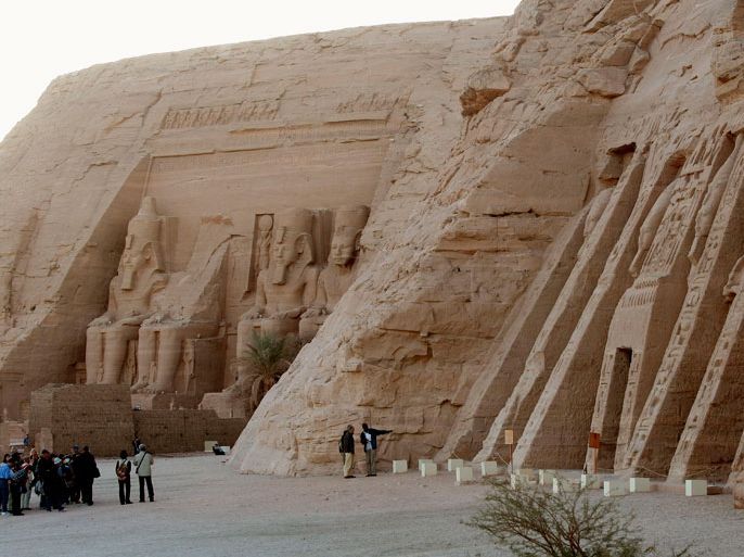 Tourists visit the temple of Pharaoh Ramses II (L) and the temple of Nubia Queen Nefertari (R) a 13th century BC temple complex at Abu Simbel next to the border of Sudan and 300 kms south of Aswan, Egypt on 15 December 2009. The Temple of Abu Simbel is a World Heritage site and consists of the Temple of Ramses II ,commemorating the Battle of Kadesh, and the Temple of Nefertari, dedicated to his Nubian wife and queen. The temples were moved to an artificial mountain following the construction of the Aswan High Dam that flooded all of the Nubian Monuments. EPA/MIKE NELSON