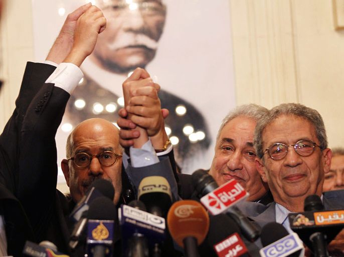 Egyptian opposition leaders, including Nobel Prize laureate Mohamed ElBaradei (L), Sameh Ashour (C), and the head of the Lawyers' syndicate and former presidential candidate Amr Moussa (R), raise their fists at the end of a joint press conference on November 22, 2012, in Cairo. Egyptian opposition forces today denounced a declaration by President Mohamed Morsi granting him sweeping powers as a "coup" and called for nationwide protests