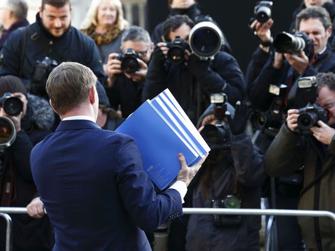 British opposition Labour member of parliament Chris Bryant poses for photographers with a copy of the Leveson Report into press ethics in central London on November 29, 2012 published after a major inquiry launched in the wake of the News Of The World phone-hacking scandal. A major inquiry called for new laws to underpin a tougher watchdog for Britain's "outrageous" newspapers in a move that threatens to split Prime Minister David Cameron's coalition government. AFP PHOTO / JUSTIN TALLIS