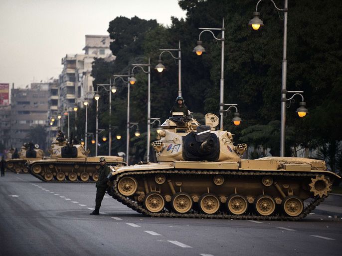 Egyptian army tanks are deployed outside the presidential palace in Cairo on December 13, 2012. Egypt's crisis showed no sign of easing as the army delayed unity talks meant to ease political divisions and the opposition set near-impossible demands for taking part in a looming constitutional referendum
