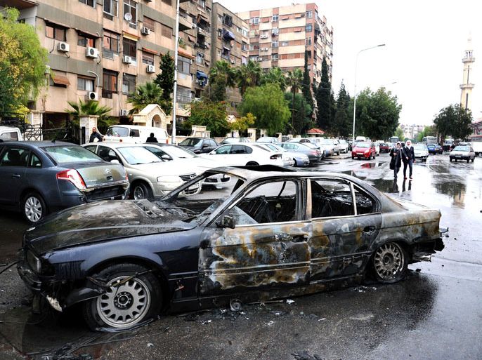 : A handout picture released by the Syrian Arab News Agency (SANA) on December 6, 2012, shows the wreckage of a car bomb after it exploded in front of a Red Crescent center in the capital Damascus. Regime forces waged fierce assaults on rebel positions around Syria, including on the outskirts of Damascus where the government is determined to regain control, a monitoring group said. AFP PHOTO/HO/SANA == RESTRICTED TO EDITORIAL USE - MANDATORY CREDIT "AFP PHOTO / HO / SANA" - NO MARKETING NO ADVERTISING CAMPAIGNS