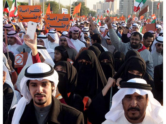 Kuwaiti opposition supporters carry placards which read in Arabic "Dignity of a Nation" as they block a major road in Kuwait City on November 30, 2012, during a demonstration against a decision by Emir Sheikh Sabah al-Ahmad al-Sabah to amend the electoral law despite it having been confirmed by a court last month. Political parties remain banned in the oil-rich Gulf emirate, although the groups act as de-facto parties. AFP
