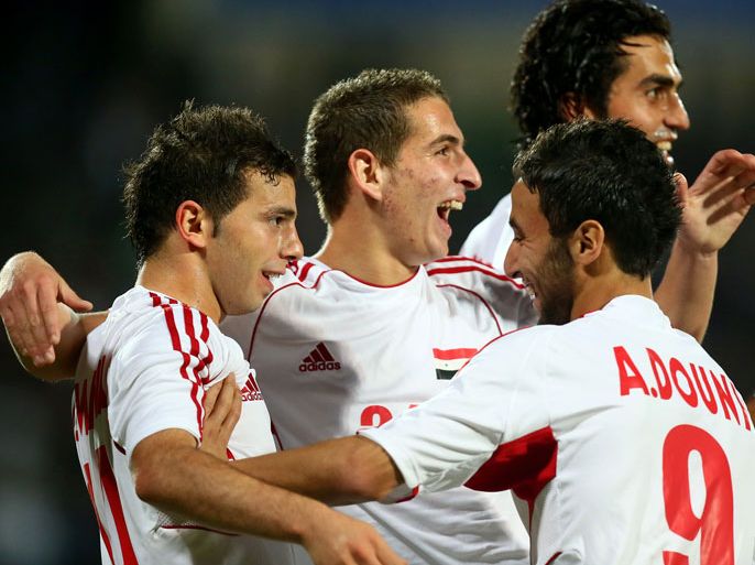 Syrian football players celebrate after scoring a goal during their semi-final football match against Bahrain in the 7th West Asia Football Federation (WAFF) championship in Kuwait City on December 18, 2012. AFP PHOTO/MARWAN NAAMANI