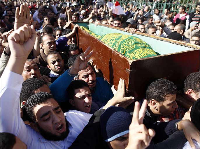 EGYPT : Egyptians carry the body of a supporter of President Mohamed Morsi during a funeral in Cairo, on December 7, 2012. Seven people died in clashes between Morsi's Islamist supporters and his mainly secular opponents on in Egypt's worst political crisis since Morsi took office in June. AFP PHOTO / MAHMOUD KHALED