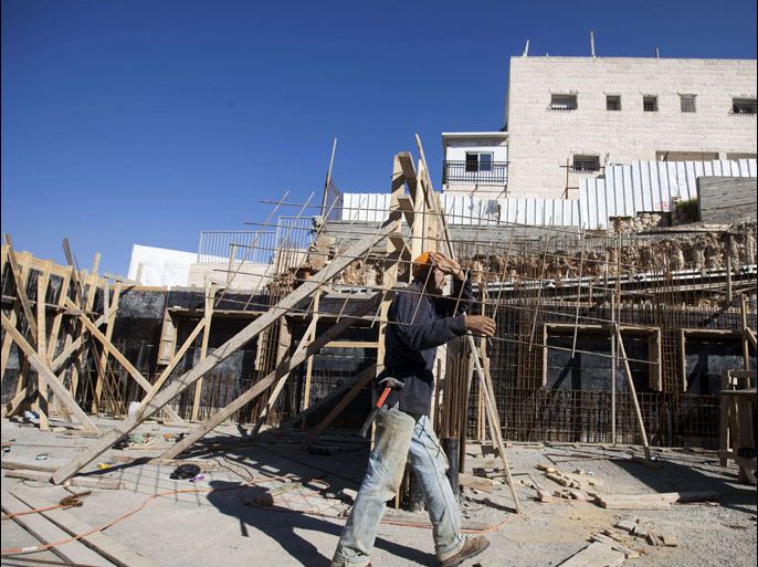 A Palestinian laborer work on a construction site in the east Jerusalem settlement of Ramat Shlomo, on December 18, 2012. Israeli planning committees are to weigh several plans for nearly 5,000 new settler homes in neighbourhoods of annexed east Jerusalem this week, with at least one major project set for final approval. The four projects are up for discussion after Israel gave the green light for the construction of 1,500 homes in the east Jerusalem neighbourhood of Ramat Shlomo, in a move which has already drawn sharp US criticism. AFP PHOTO/AHMAD GHARABLI
