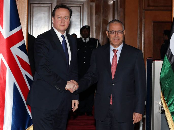 Libyan prime minister Ali Zaidan (R) greets British Prime Minister David Cameron (L) ahead of their meeting as part of the British PM visit in Libya on January 31, 2013 in Tripoli. Cameron does a surprise visit in Libya following a one-day-visit in Algeria in the wake of this month's hostage crisis in the Sahara in which several Britons were killed.