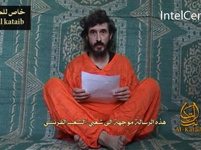French hostage Denis Allex is seen in this frame grab. An Islamist group in Somalia has issued a video of Allex, held in the Horn of Africa country, showing him asking France to meet his captors' demands. A copy of the video issued by U.S.-based SITE Intelligence Group, which monitors militant internet traffic, shows the captive in an orange outfit with armed men standing behind him while he reads a statement in French.