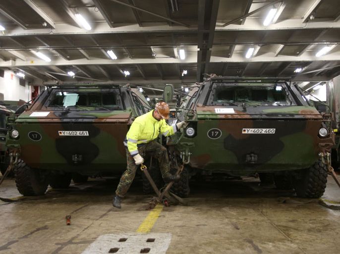 Soldier controls load safety of the ABC-search-tank 'Fuchs' during the loading of 'Patriot' defence missiles on board for the mission in Turkey in the harbor of Luebeck-Travemuende in Luebeck, Germany, 08 January 2013