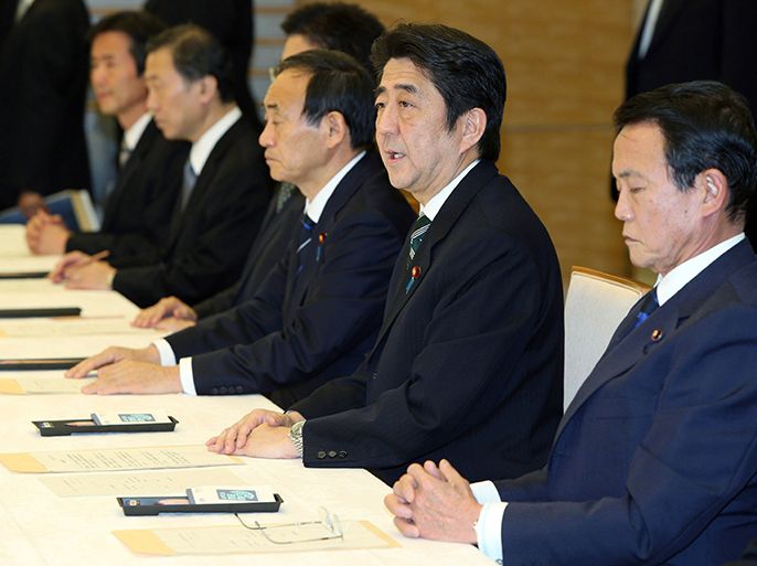 Japanese Prime Minister Shinzo Abe (2R), accompanied by Deputy Prime Minister Taro Aso (R), attends a cabinet-level meeting to co-ordinate its response to hostage issues in Algeria at the prime minister's official residence in Tokyo on January 21, 2013. Abe said seven Japanese deaths had been confirmed in the Algerian hostage crisis, the first official confirmation from Tokyo that any of its nationals had died. AFP PHOTO / JIJI PRES JAPAN OUT