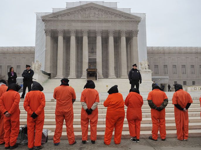 Washington, District of Columbia, UNITED STATES : Hooded demonstrators take part in a rally to call for the closing of the Guantanamo Bay detention center on January 11, 2013 in front of the US Supreme Court on Capitol Hill in Washington. AFP PHOTO/Mandel NGAN