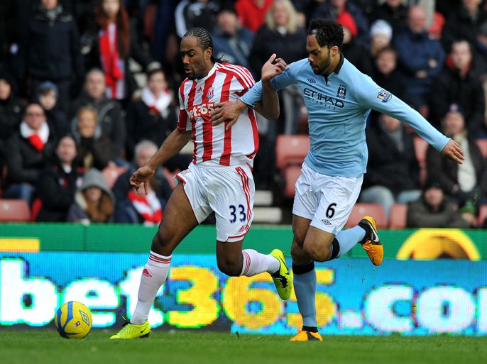 Manchester City's English defender Joleon Lescott (R) tackles Stoke City's English striker Cameron Jerome during the English FA Cup fourth round football match between Stoke City and Manchester City at The Britannia Stadium in Stoke-on-Trent, Liverpool, England on January 26, 2013. Manchester City won 1-0. AFP PHOTO