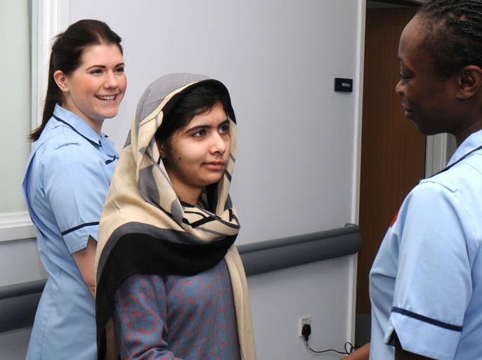 Birmingham, West Midlands, UNITED KINGDOM : A handout picture recieved on January 4, 2013 and taken January 3, 2013 from the Queen Elizabeth Hospital in Birmingham shows injured 15 year-old Pakistani schoolgirl Malala Yousafzai flanked by two members of the hospital staff as she is discharged from the Queen Elizabeth Hospital in Birmingham in central England. Malala shot by the Taliban for campaigning for girls' education has been discharged from the British hospital treating her, a hospital spokeswoman said on January 4, 2013. Queen Elizabeth Hospital in Birmingham, central England, said 15-year-old Malala Yousafzai would continue her rehabilitation at her family's temporary English home before undergoing major reconstructive surgery in a few weeks. RESTRICTED TO EDITORIAL USE - MANDATORY CREDIT " AFP PHOTO / QUEEN ELIZABETH HOSPITAL " - NO MARKETING NO ADVERTISING CAMPAIGNS - DISTRIBUTED AS A SERVICE TO CLIENTS