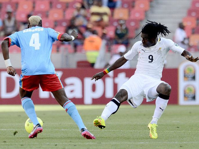 Ghana's midfielder Derek Boateng (R) vies for the ball with Democratic Republic of Congo's forward Patou Kabangu during their 2013 African Cup of Nations football match