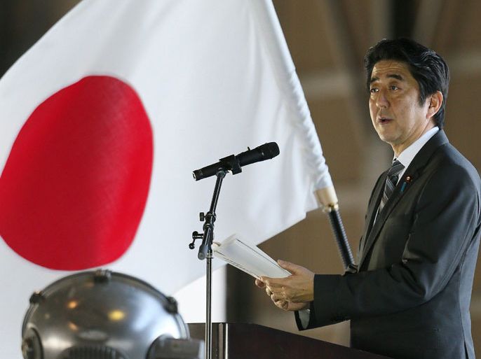 Japanese Prime Minister Shinzo Abe delivers a speech upon his arrival at Naha air base in Japan's southern island of Okinawa on February 2, 2013 for the first visit to Okinawa since becoming premier in December. Abe vowed to defend Japan against "provocations" as he toured the southern region of Okinawa near islands at the centre of a boiling territorial dispute with China. AFP PHOTO / JIJI PRESS JAPAN OUT