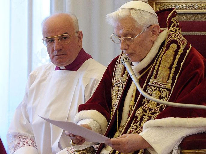 Pope Benedict XVI, right, reads a document in Latin as he announces his resignation. (AP Photo/L’Osservatore Romano, ho)