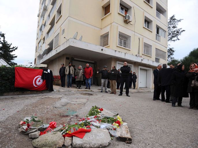 Tunis, -, TUNISIA : A national flag and flowers are displayed in front of the home of Tunisian opposition leader and outspoken government critic Chokri Belaid where he was shot dead on February 6, 2013 in Tunis. Belaid was gunned down outside his home, sparking angry protests by his supporters and attacks on offices of the ruling Islamist Ennahda party. AFP PHOTO / FETHI BELAID