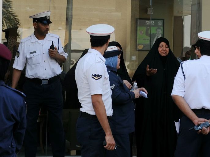 epa02517874 An unidentified Bahraini woman (2R) reacts to the arrest of a youth outside the courthouse in Manama, Bahrain, on 06 January 2011. The court case by the Bahraini government against alleged ring-leaders of an all Shiite terror network, suffered a major set-back on 6 January 2011 after 19 out of 23 court-appointed lawyers withdrew from the case. The withdrawal came on the heels of an earlier withdrawal last month by the original 21-member advocates' team that had volunteered to represent the 25 detainees - all of whom are out spoken critics of the government. EPA/Mazen Mahdi