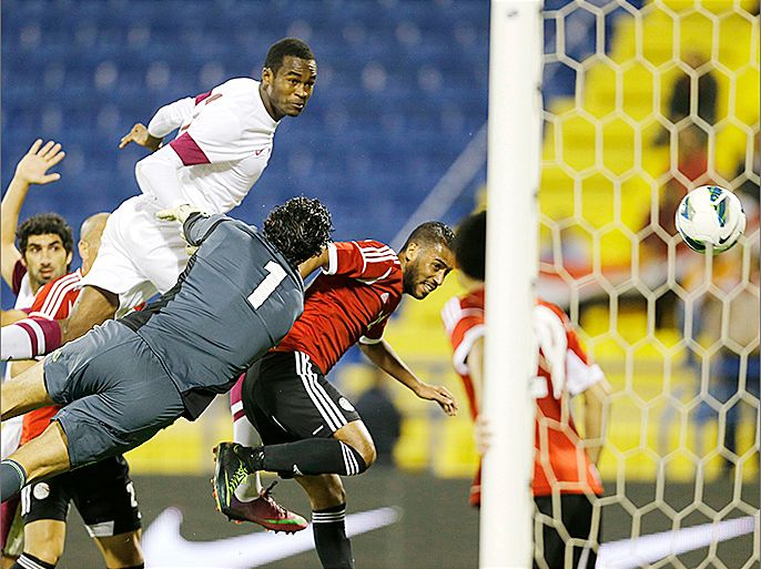 Qatar's Abdulkarim Hassan (top) scores a goal past Egypt's goalkeeper Sherif Ekramy during their international friendly soccer match in Doha March 7, 2013. REUTERS/Fadi Al-Assaad (QATAR - Tags: SPORT SOCCER)