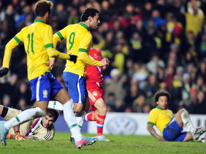Brazil's striker Fred (C) scores the equalising goal with defender Marcelo (L) during the international friendly football match between Brazil and Russia at Stamford Bridge stadium in London on March 25, 2013. The match ended in a 1-1 draw. AFP PHOTO / GLYN KIRK