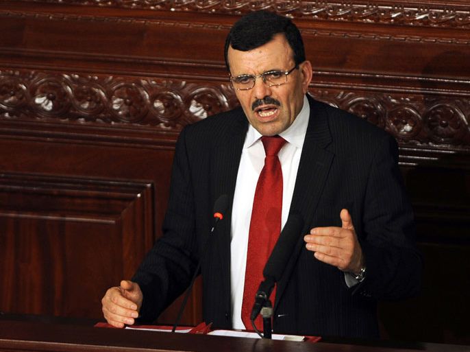 Tunisian premier-designate Ali Larayedh addresses a parliament session held to vote on his cabinet line-up in Tunis on March 12, 2013. A street vendor in Tunis suffered severe burns when he set himself alight in an act of desperation hours before a vote on a new government to pull Tunisia out of a long-running political crisis. AFP PHOTO / FETHI BELAID