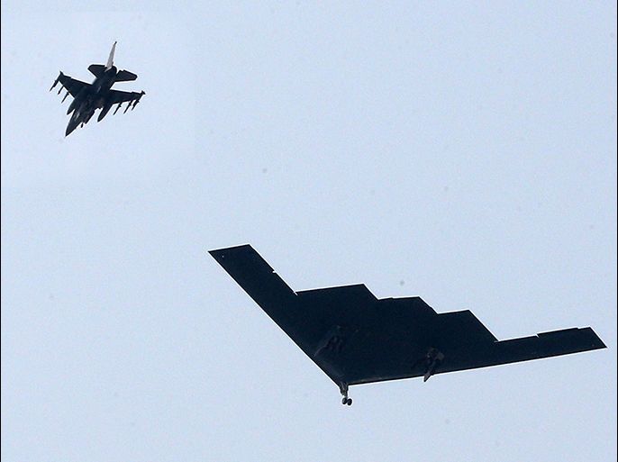 A US B-2 stealth bomber (R) flies over a US air base in Pyeongtaek, south of Seoul, on March 28, 2013 as part of South Korea-US joint military exercise. Two nuclear-capable US B-2 stealth bombers flew what the US military described as "deterrence" missions over South Korea on March 28, in a move sure to further inflame tensions with North Korea.  REPUBLIC OF KOREA OUT  NO ARCHIVES  NO INTERNET    RESTRICTED TO SUBSCRIPTION USE     AFP PHOTO/YONHAP