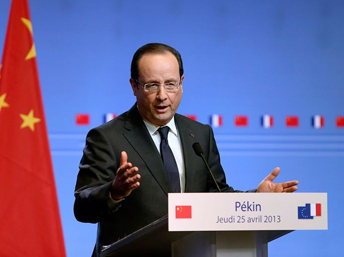 French President Francois Hollande talks to the media during a news conference during his two-day state visit, in Beijing April 25, 2013. Picture taken April 25, 2013. REUTERS/Stringer (CHINA - Tags: POLITICS BUSINESS) CHINA OUT. NO COMMERCIAL OR EDITORIAL SALES IN CHINA