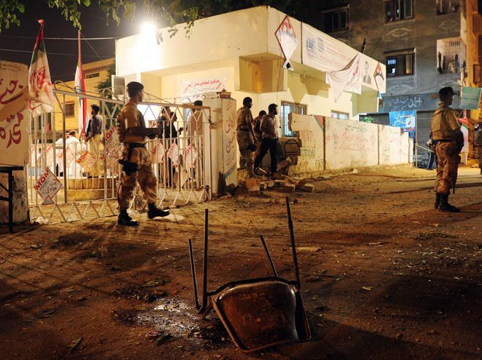Pakistani security officials cordon off the site of twin bomb blasts near the secular Muttahida Qaumi Movement (MQM) party office in Karachi on May 4, 2013. Three people were killed and more than 20 others wounded in the blasts near the local party office, police said, ahead of next week's historic elections