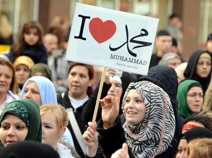 photo made available on 30 September 2012 shows a female protester holding a banner reading: 'I love (the Prophet) Muhammad' during a demonstration in Hamburg, Germany, 29 September 2012. Some 250 people gathered in the city to protest disrespect against Islam and the Prophet Muhammad. Muslims worldwide are protesting against an anti-Islam movie made in the US which is deemed to insult the Prophet Muhammad. The video was posted to YouTube several months ago. EPA/Daniel Bockwoldt