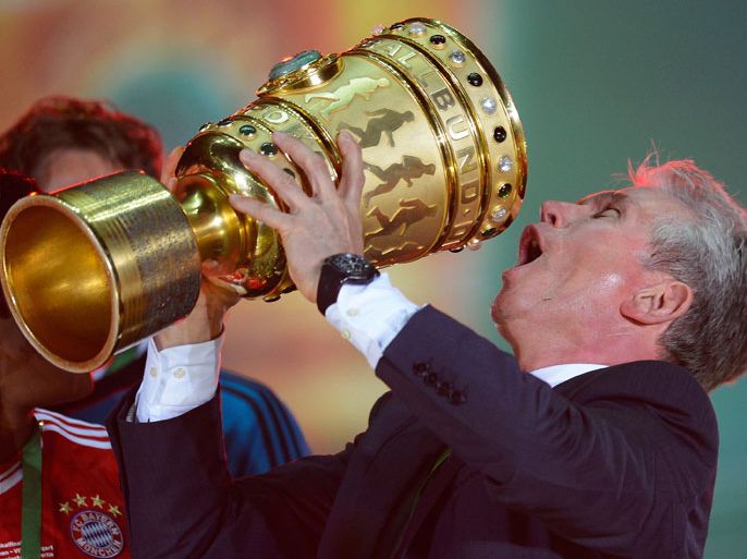 Bayern Munich's head coach Jupp Heynckes celebrates with the trophy after they won the final football match of the German Cup (DFB - Pokal) FC Bayern Munich vs VfB Stuttgart on June 1, 2013 in Berlin. AFP PHOTO / ROBERT MICHAELcelebrate after the final football match of the German Cup (DFB - Pokal) FC Bayern Munich vs VfB Stuttgart on June 1, 2013 in Berlin. Champions League winners Bayern Munich became the first Bundesliga champion to win the treble after their hard-earned 3-2 win over plucky VfB Stuttgart in Saturday's German Cup final. AFP PHOTO / ROBERT MICHAEL