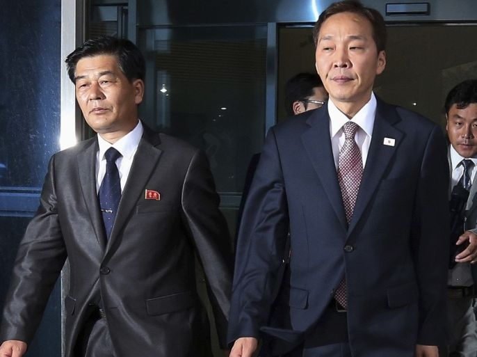 Head of the South Korean working-level delegation, Kim Ki-woong (R) walks with his North Korean counterpart Park Chol-su after their talks at Kaesong Industrial District Management Committee in Kaesong July 15, 2013. South and North Korea began their third working-level talks on Monday to discuss the normalisation of operations at the jointly run industrial park, including the resumption of facility inspections, reported local media.