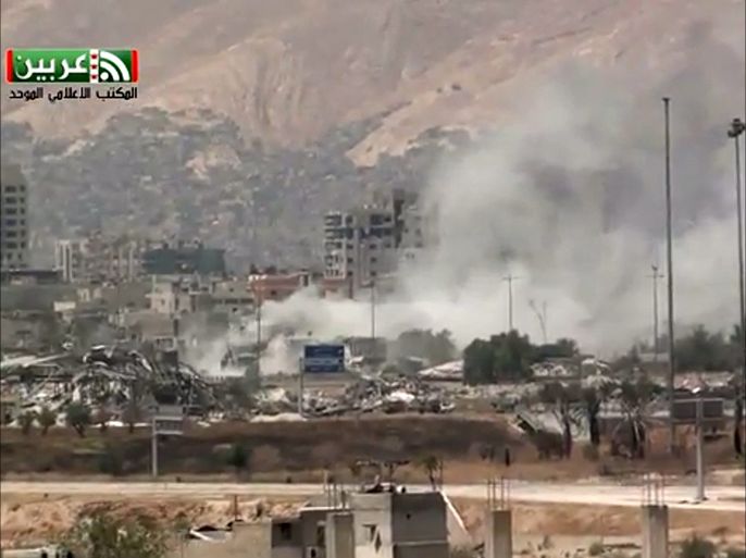 In this image taken from video obtained from Ugarit News, which has been authenticated based on its contents and other AP reporting, shows shelling of the Al-Qaboun neighborhood in rural Damascus, Syria, Monday, July 15, 2013. After seizing the momentum in recent months in Syria's civil war, President Bashar Assad's forces are on the offensive against the rebels on several fronts, including in Idlib province along the border with Turkey. Government forces are in firm control of the provincial capital of same name, while dozens of rebel brigades control the countryside.