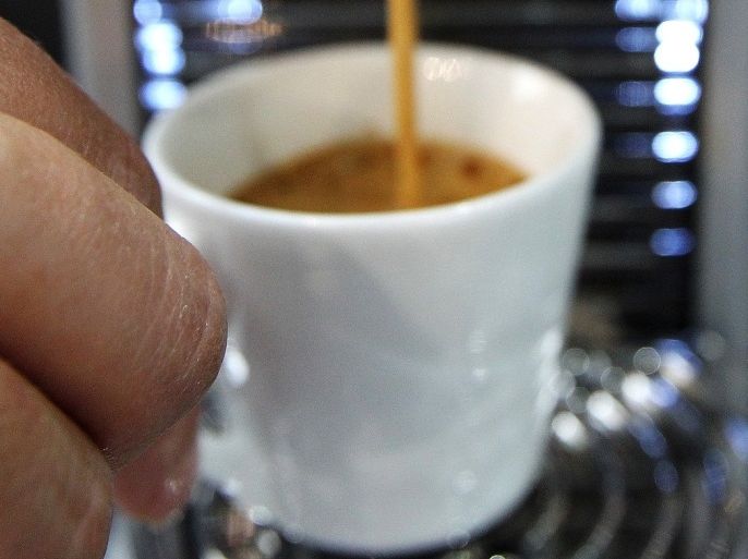 A person prepares a cup of coffee Nespresso during the exhibition 'World of coffee', on June 27, 2013, in Nice, southeastern France.