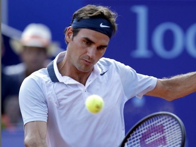 Switzerland's Roger Federer returns the ball to Germany's Daniel Brands during their Suisse Open match in Gstaad July 25, 2013.