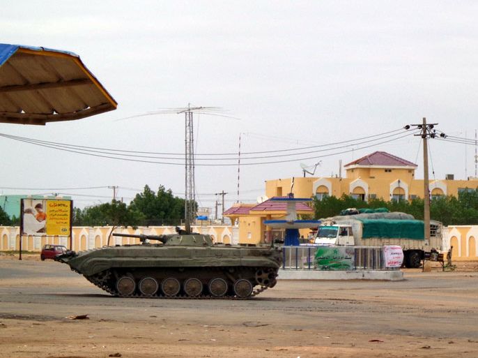 An Algerian military tank is stationed near a Sudanese security facility in the city of Nyala, in the Darfur region, on July 4, 2013, following an attack during a battle which officials in South Darfur state blamed on "differences" between members of the security forces. Two Sudanese workers for the aid group World Vision remained in critical condition, a humanitarian source said, following a grenade strike which killed their co-worker during the fighting in the Darfur region. AFP PHOTO