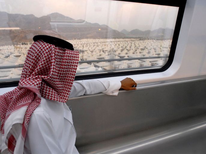 epa02375981 A Saudi man looks at the tent city of as he sits onboard the new fast commuter train Mashair (Mecca Metro) on its first run test in Mecca, Saudi Arabia, 05 October 2010. The Mashair fast commuter train which has started om 05 October a 30 days test run period, is capable of reaching speeds up to 300 km per hour. It runs from Mecca to Medina through Jeddah's King Abdul Aziz International airport and connects the Haj holy sites making it easier for the some three million Muslim Haj pilgrims, to reach all the sites instead of using buses and private vehicles. EPA/STR