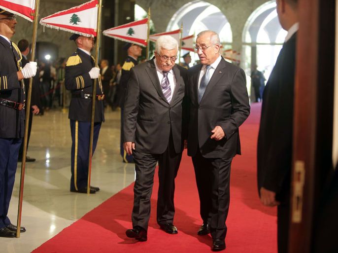 BEI773 - Beirut, -, LEBANON : Palestinian president Mahmud Abbas (L) review the guard of honour with Lebanese President Michel Sleiman (R) at the presidential palace of Baabda on July 3, 2013. Abbas flew to Lebanon via Jordan, and is expected to offer the Lebanese authorities assurances that the Palestinian refugee camps will stay clear of the country's growing Syria-related unrest during his three day visit. AFP PHOTO/JOSEPH EID