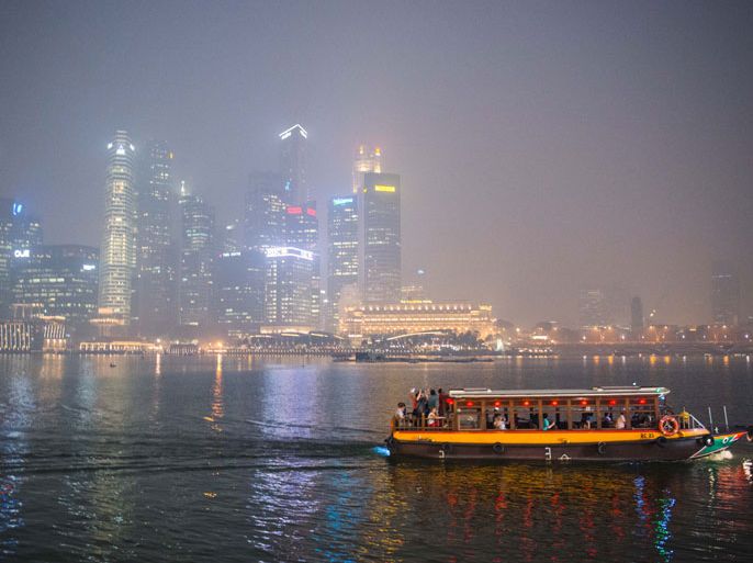 epa03751419 A boat ferrying tourists is seen against a skyline shrouded in haze in Singapore, Singapore, 19 June 2013. Smoky haze from Indonesia's forest fires choked Singapore and Malaysia, prompting both governments to issue health warnings to their citizens. Singapore's Pollutant Standards Index rose to 172 in the afternoon, a 16-year high. EPA/SAMUEL HE