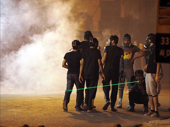 Protesters wearing gas masks gather as riot police fire tear gas during clashes in the village of Diraz, west of Manama July 18, 2013. REUTERS/Hamad I Mohammed (BAHRAIN - Tags: POLITICS CIVIL UNREST)