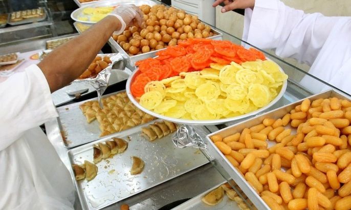 A Kuwaiti customer orders sweets at a pastry shop during the Muslim fasting month of Ramadan, on July 16, 2013, in Kuwait City. Muslims fasting in the month of Ramadan must abstain from food, drink and sex from dawn to dusk, when they break the fast with a meal known as iftar.