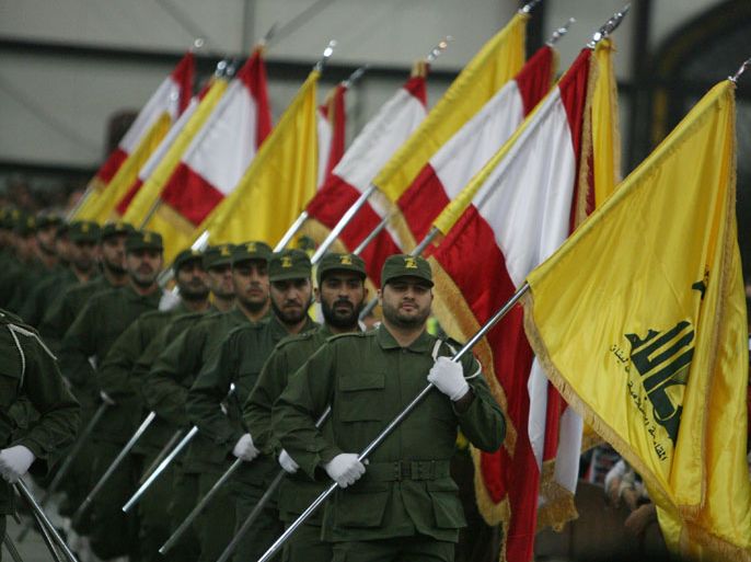 Beirut, -, LEBANON : (FILES) A picture taken on November 11, 2009, shows Hezbollah fighters, holding up Lebanese flags and the yellow flag of the militant Shiite Muslim group, as they parade on the occasion of Martyr's Day in the southern suburbs of Beirut. EU foreign ministers decide on July 22, 2013 whether to blacklist the military wing of Lebanon's Hezbollah group, with an eye also on the conflict in Syria and the possible resumption of stalled Israel-Palestinian talks. AFP PHOTO/RAMZI HAIDAR