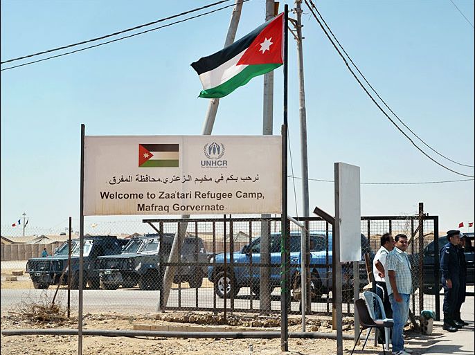 A sign is posted at a perimeter fence of the Zaatari refugee camp on July 18, 2013 near the Jordanian city of Mafraq, some 8 kilometers from the Jordanian-Syrian border. The northern Jordanian Zaatari refugee camp, now home to 160,000 Syrians, equal in size to what would be Jordan's fifth-largest city. AFP PHOTO/MANDEL NGAN/POOL