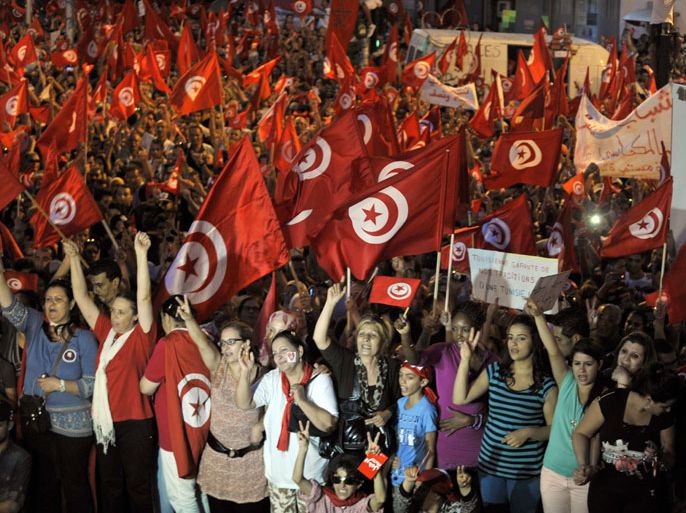 Tunis, -, TUNISIA : Demonstrators take part in a protest against the country's Islamist-led government in front of the Constituent Assembly headquarters in Tunis on August 13, 2013, which marks national women's day, as the president proposed a national unity cabinet to end a protracted crisis. The government, led by the Islamist Ennahda party, and its detractors have been locked in a bitter feud sparked by the July assassination of an opposition politician, the second such killing this year. AFP PHOTO / FETHI BELAID