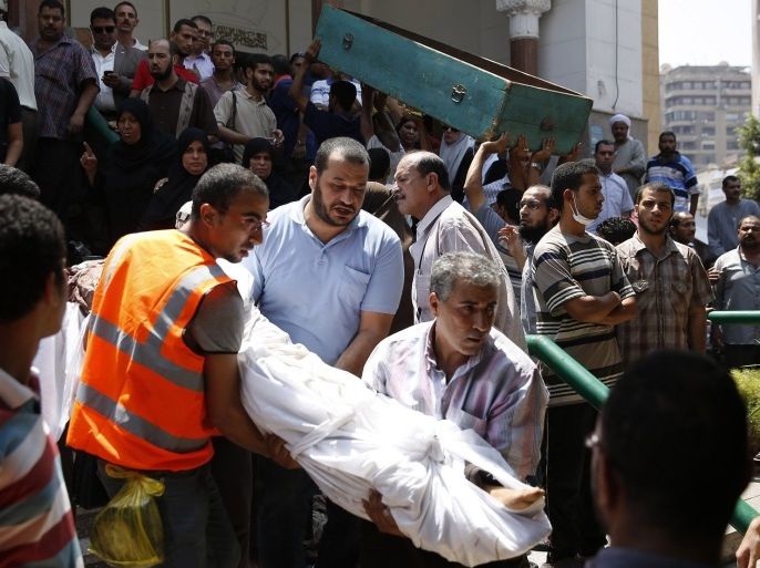 The body of a victim killed during yesterday's clashes is carried from a mosque in Cairo, August 15, 2013. Hundreds of supporters of Egypt's Muslim Brotherhood stormed the government building in Cairo on Thursday and set it ablaze, as fury over a security crackdown on the Islamist movement that killed hundreds of people spilled on to the streets.