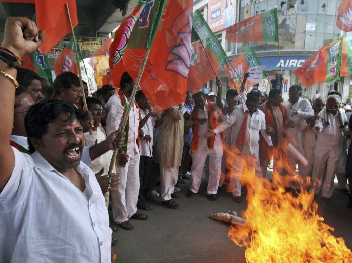 Activists of India's main opposition Bharatiya Janata Party (BJP) shout slogans and burn an effigy of Pakistan s spy service, Inter Services Intelligence (ISI) during a protest against the death of five Indian army soldiers in cross-border exchanges, in Hyderabad, India, Wednesday, Aug. 7, 2013. India's army said five of its soldiers were killed and another wounded when Pakistani troops fired at a patrol near the cease-fire line in the disputed Himalayan region of Kashmir on Tuesday. The incident could threaten recent overtures aimed at resuming peace talks between the nuclear-armed rivals.